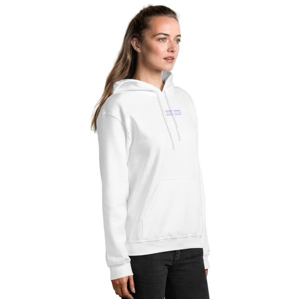 Person wearing a white hoodie with a logo on a light gray brick wall background