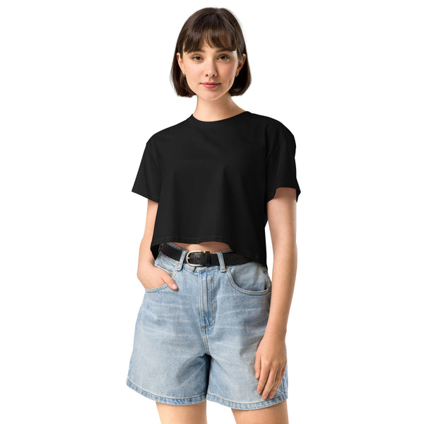 Person wearing a black t-shirt and denim shorts on a white background