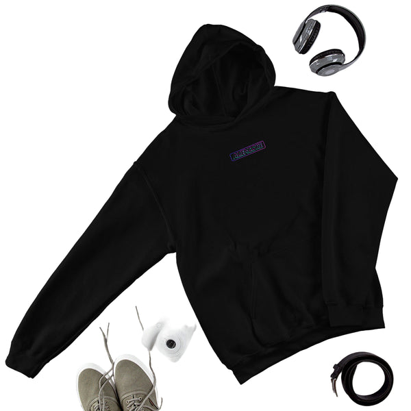 Black hoodie with a brand logo on a gray surface with jeans, shoes, and accessories.