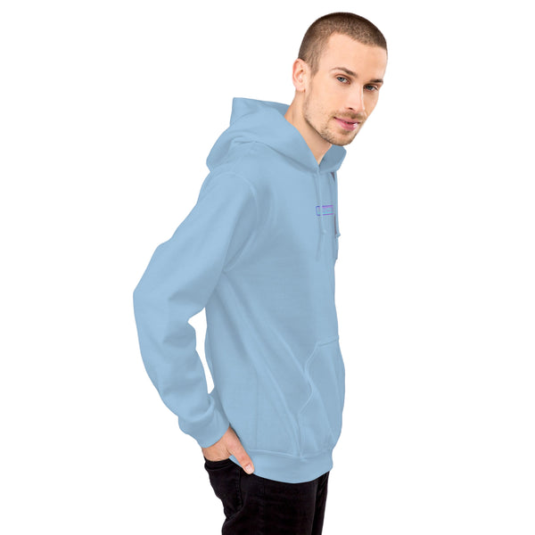 Man wearing a light blue hoodie against a gray wall