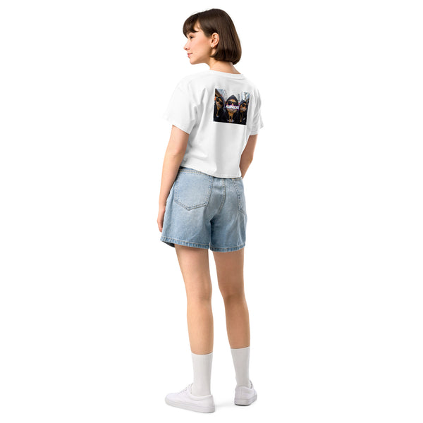 Person wearing a white t-shirt with a graphic design and denim shorts on a white background