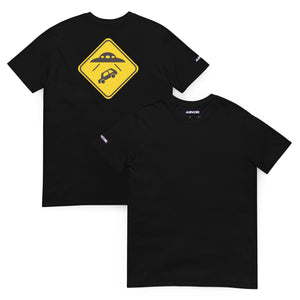 Black t-shirt with a yellow UFO warning sign design on a white background