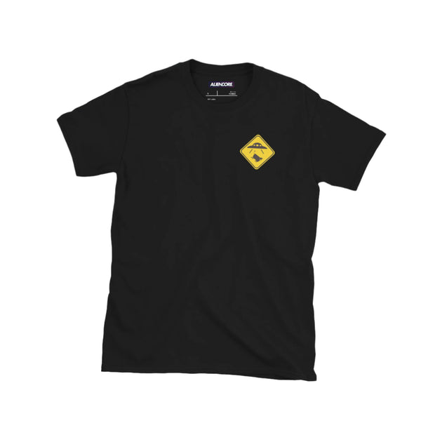 Black t-shirt with a yellow and black logo on a light gray surface with accessories around.
