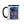 Mug with a colorful design of an alien reading a book, surrounded by plants, on a white background.