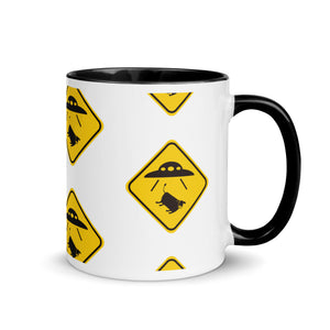 Mug with yellow warning signs featuring UFOs on a white background