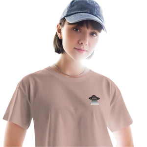 Person wearing a beige t-shirt with a small graphic on a white background