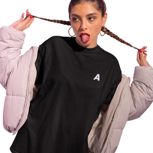 Person wearing a black sweatshirt with a white letter 'A' on a purple background