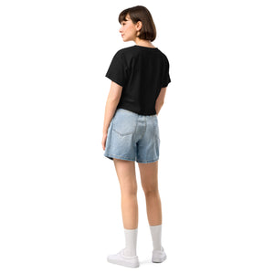 Person wearing a black t-shirt and denim shorts on a white background