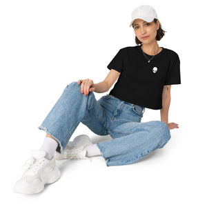 Person wearing a black t-shirt, blue jeans, and white sneakers on a white background
