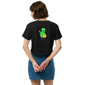 Person wearing a black t-shirt with a green alien design on the back, standing against a white background.