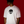 Person wearing a white t-shirt with an alien logo on a red background