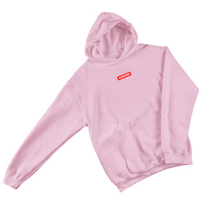 Pink hoodie with a red logo on a gray surface with jeans, shoes, and accessories.