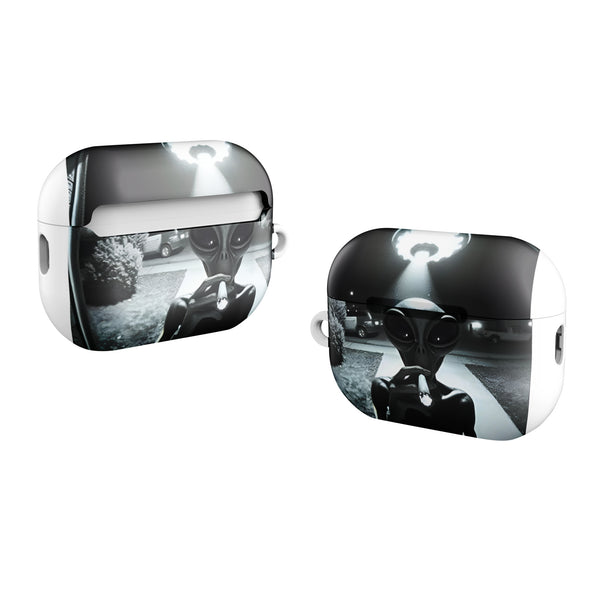Silver AirPod cases with alien design on a white background