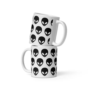 Two white mugs with black alien head pattern on a white background
