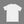 White t-shirt on a light gray surface with a camera, phone, and glasses.