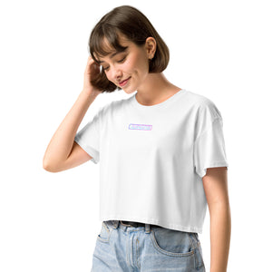 Woman wearing a white t-shirt with a small logo on a white background